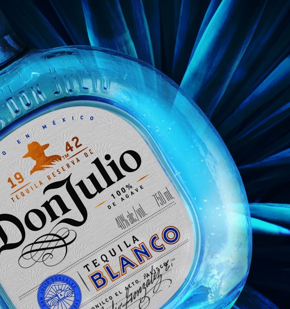Bottle of Don Julio Blanco with an agave plant in the background